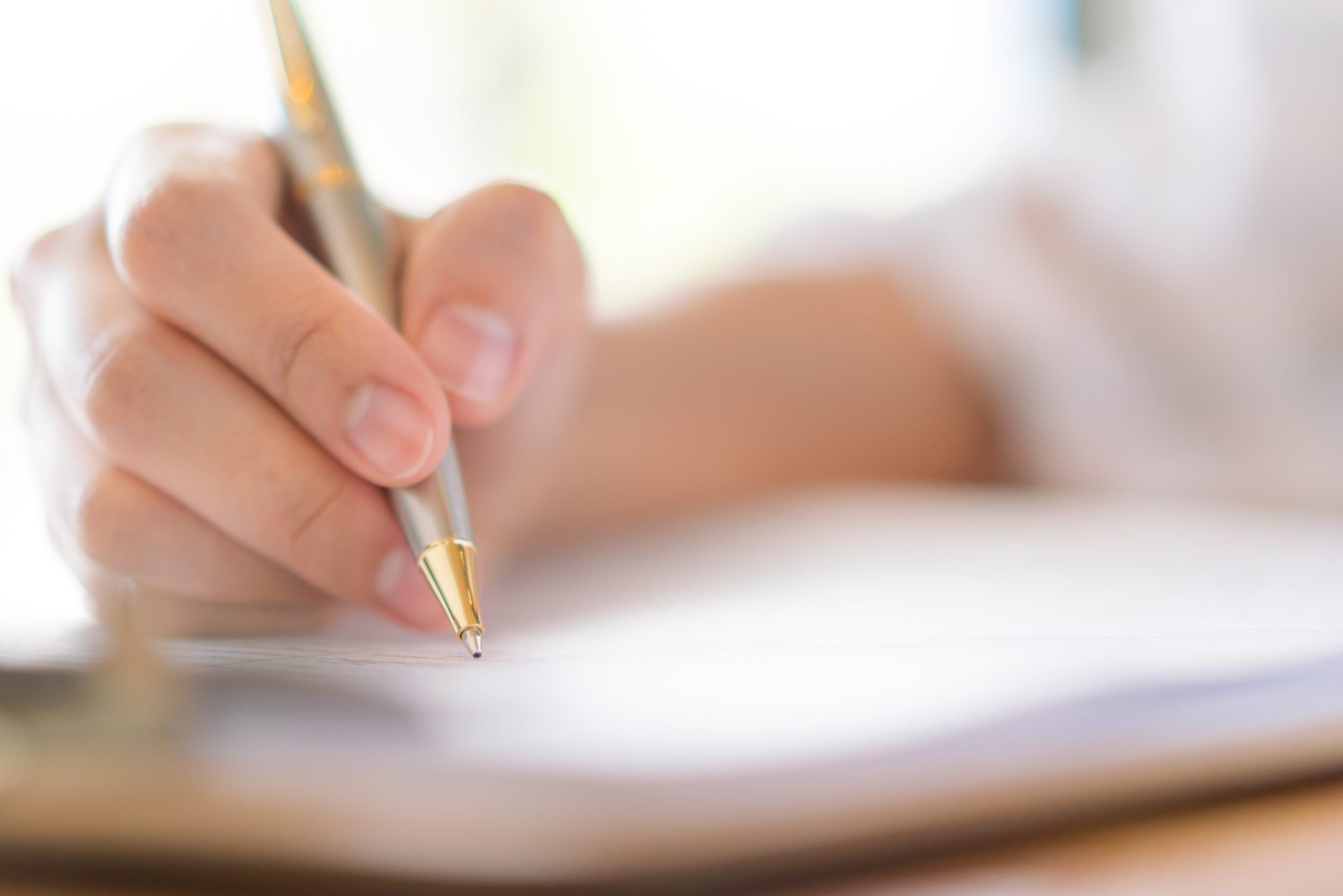 Hand with pen over application form services